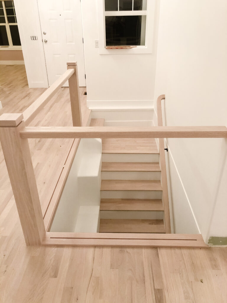 Site finished hardwood floor with stain matched railing and stair treads