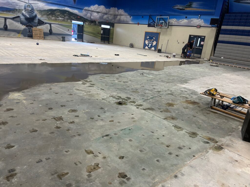 New gym floor during photo showing floor levelling compound being applied