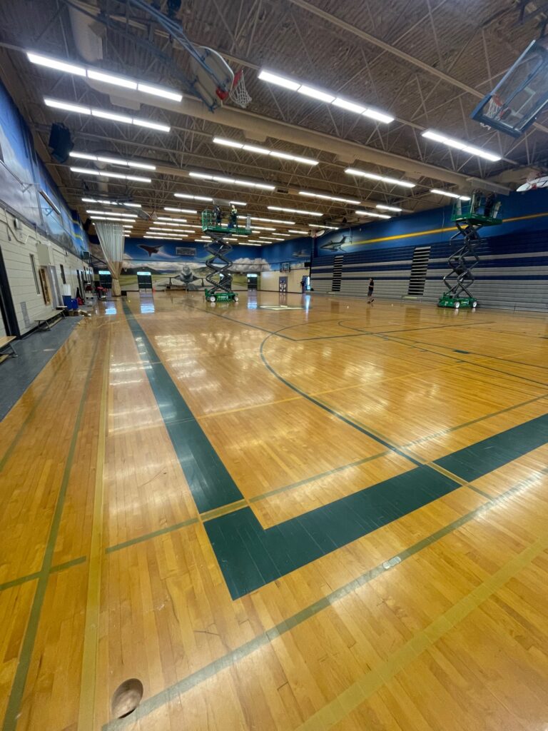 Before photo of an old gymnasium school floor