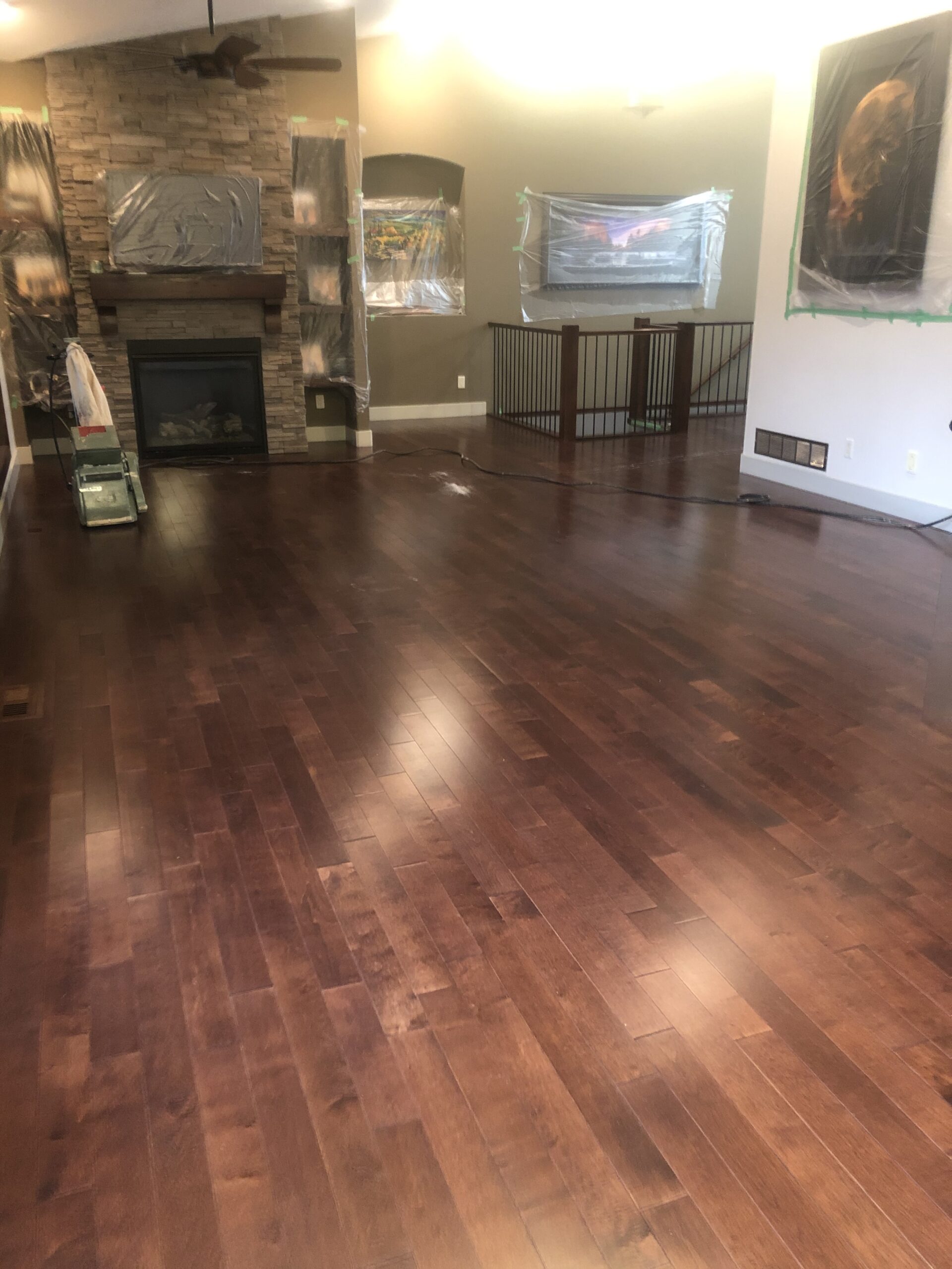 Damaged hardwood floor before refinish with scratches and discolouration
